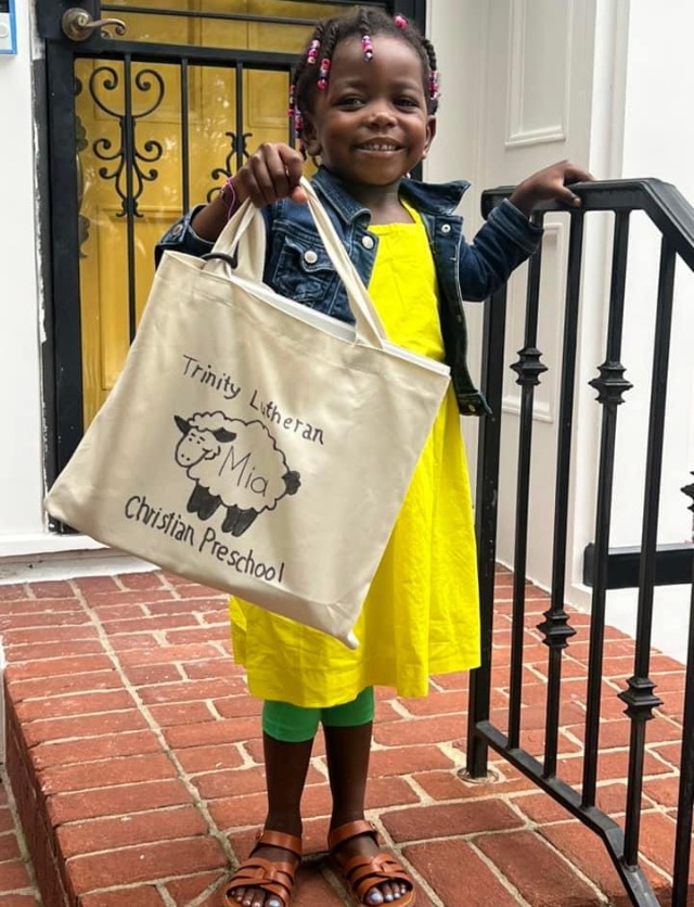 child posing with bag for back to school picture