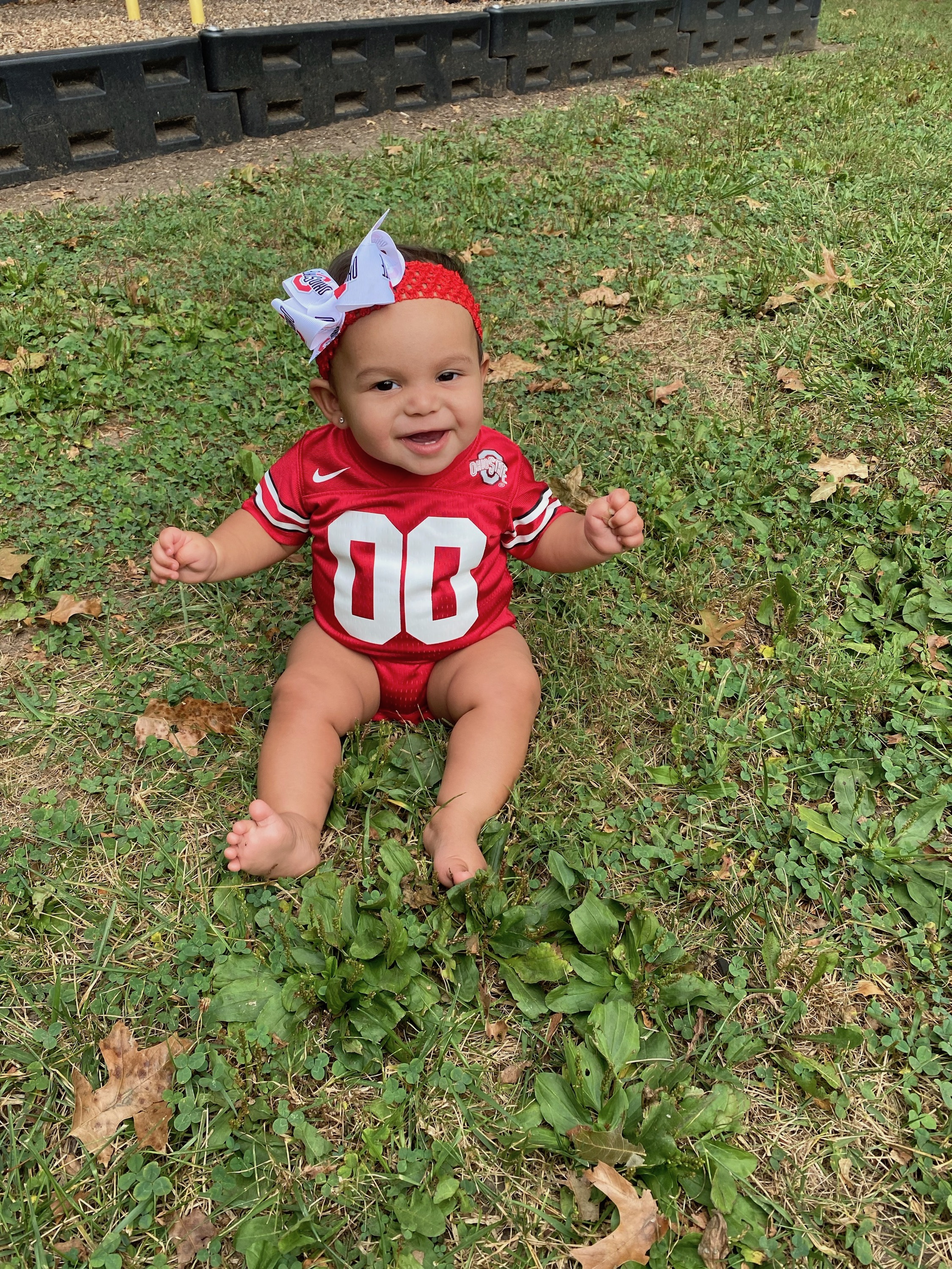 baby in grass in buckeye gear